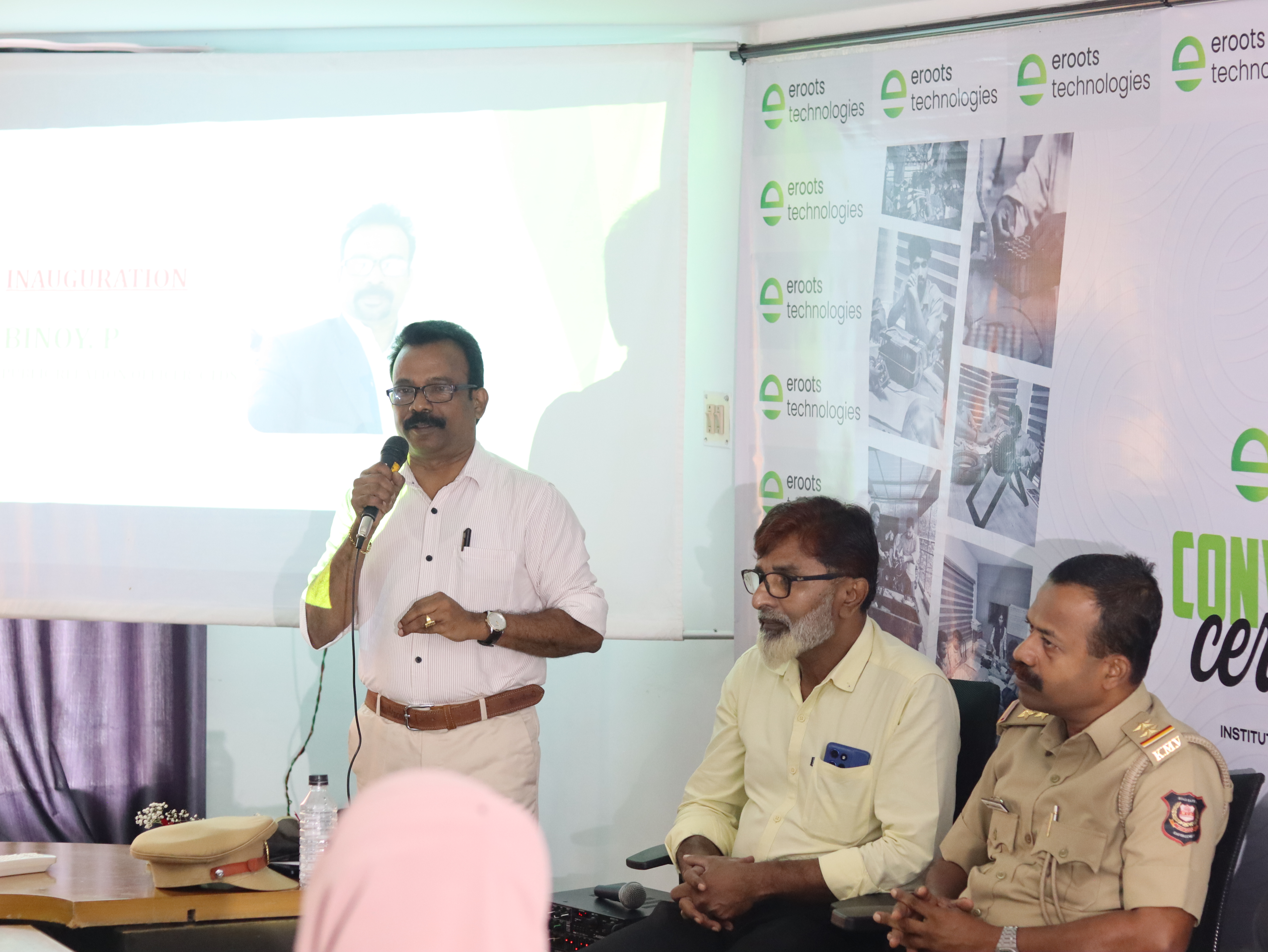 Speaker sharing remarks during an Eroots Technologies ceremony.