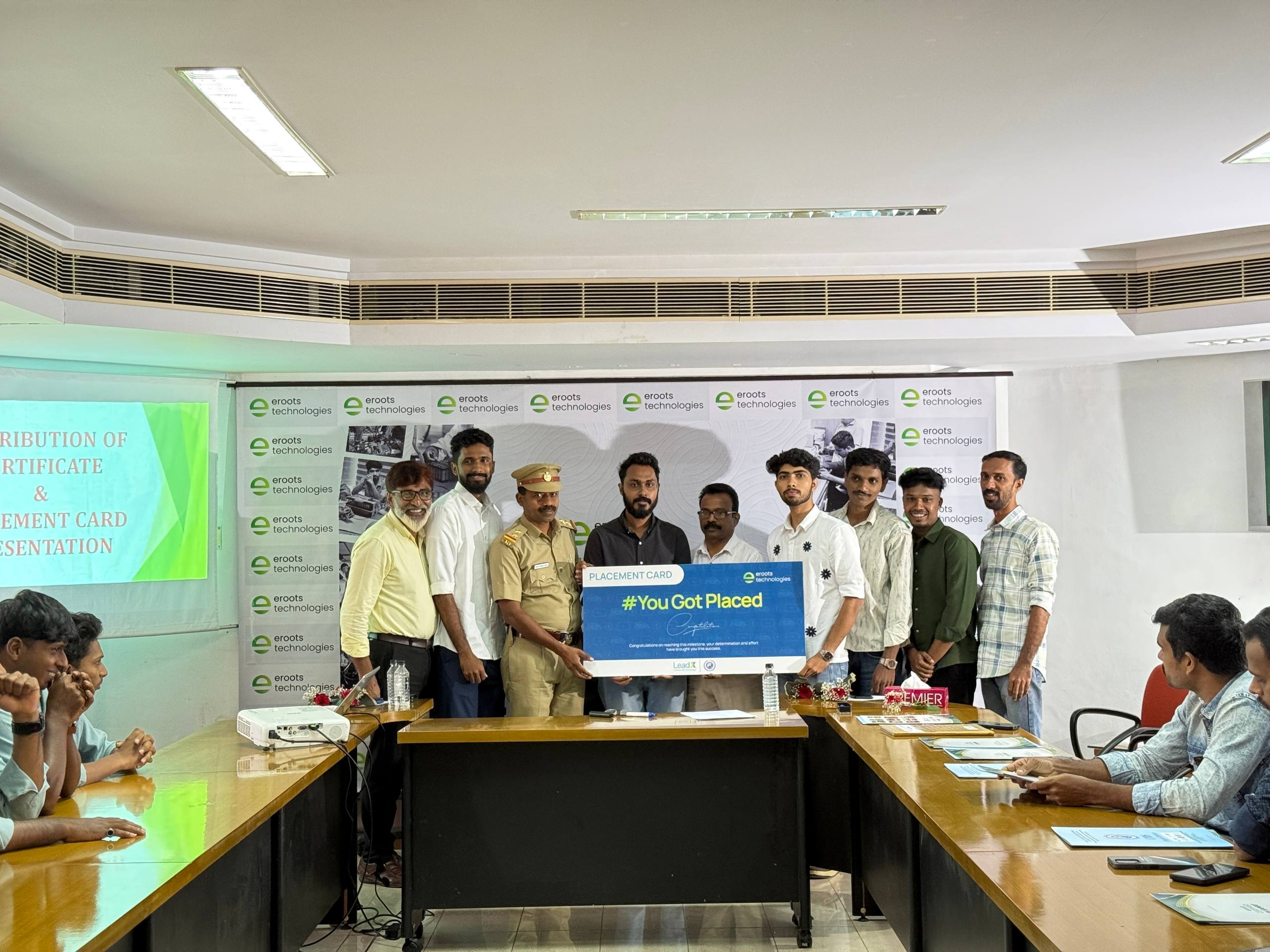 Placement card presentation at Eroots Technologies event hall.