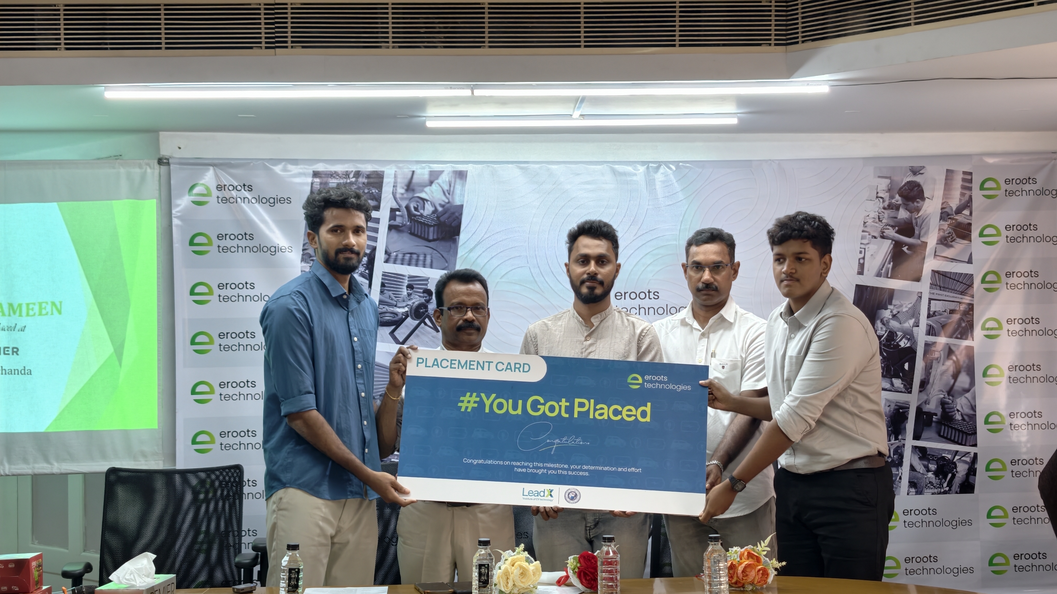 Placement card presentation photo with Eroots Technologies participants.