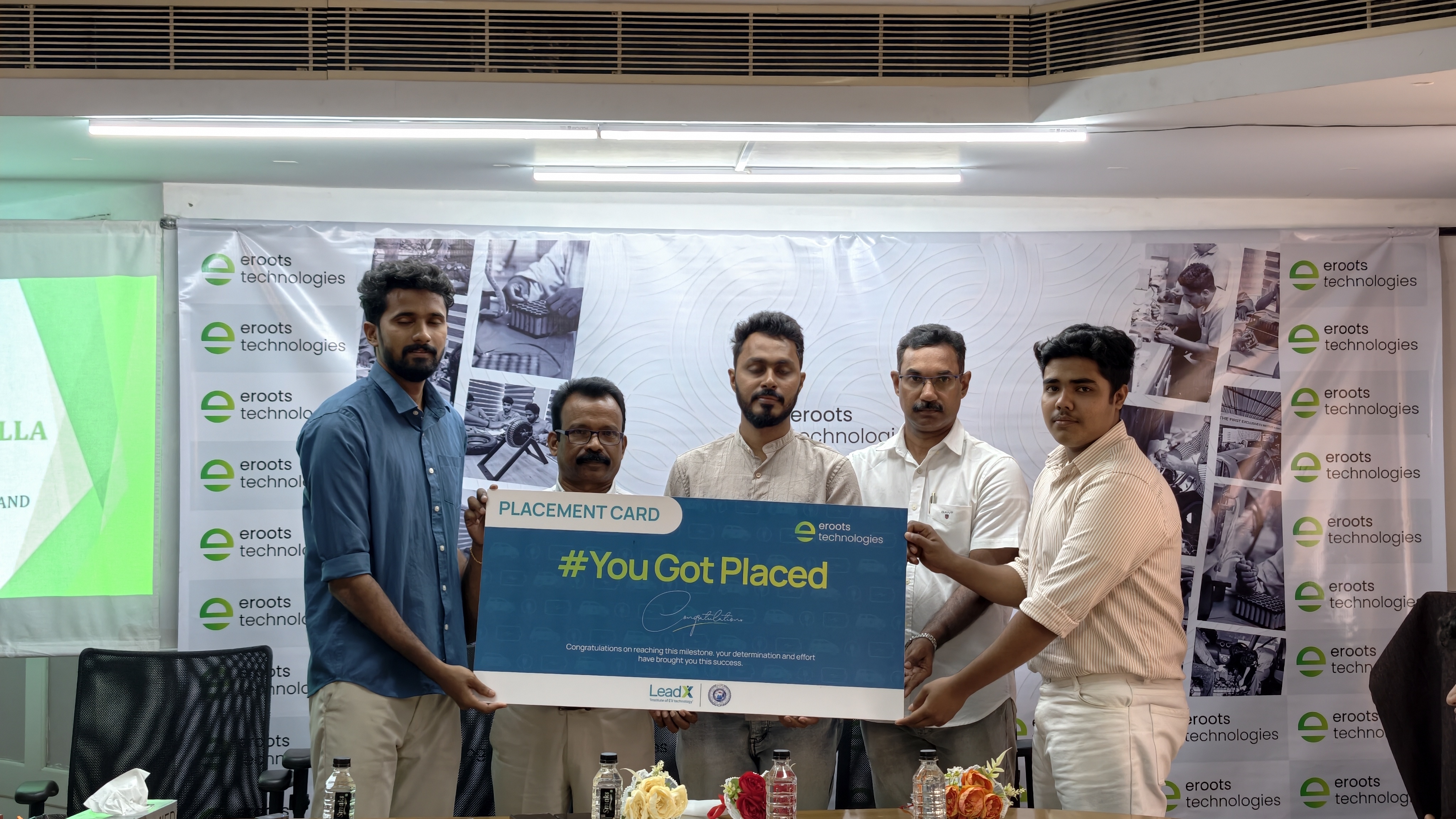 Placement card group photo during Eroots Technologies ceremony.