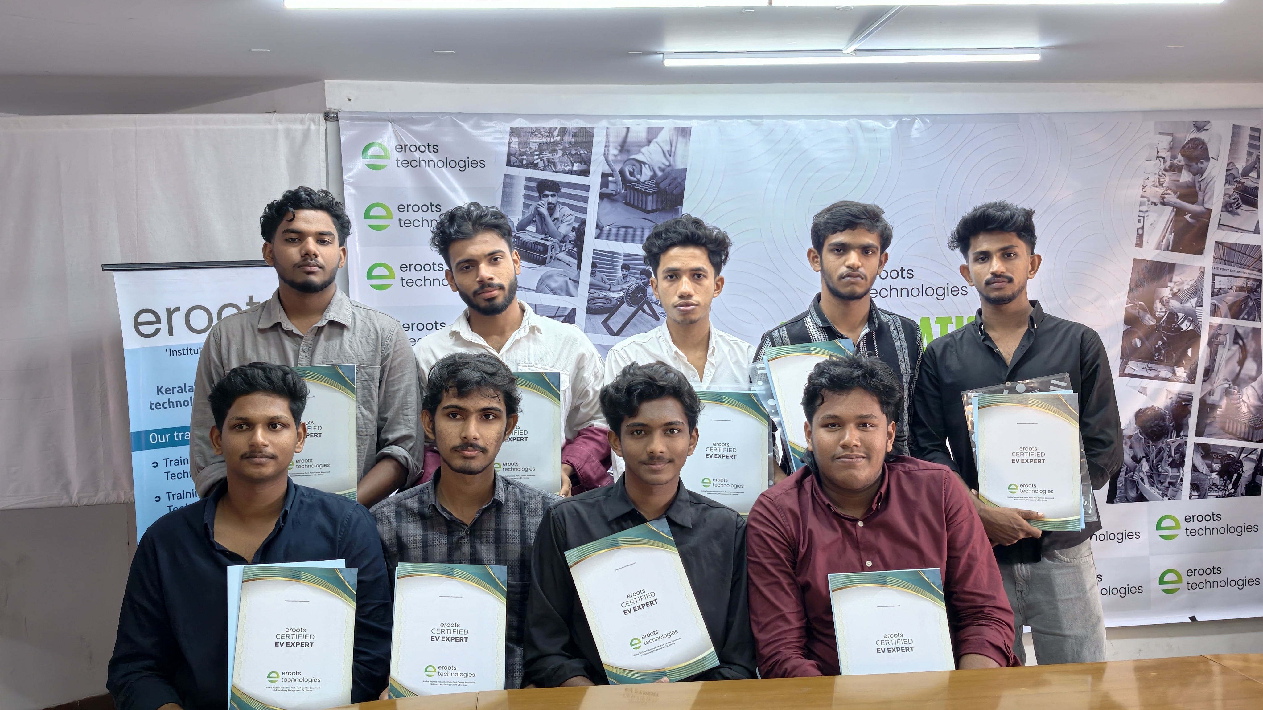 Close group shot of students holding EV expert certificates.