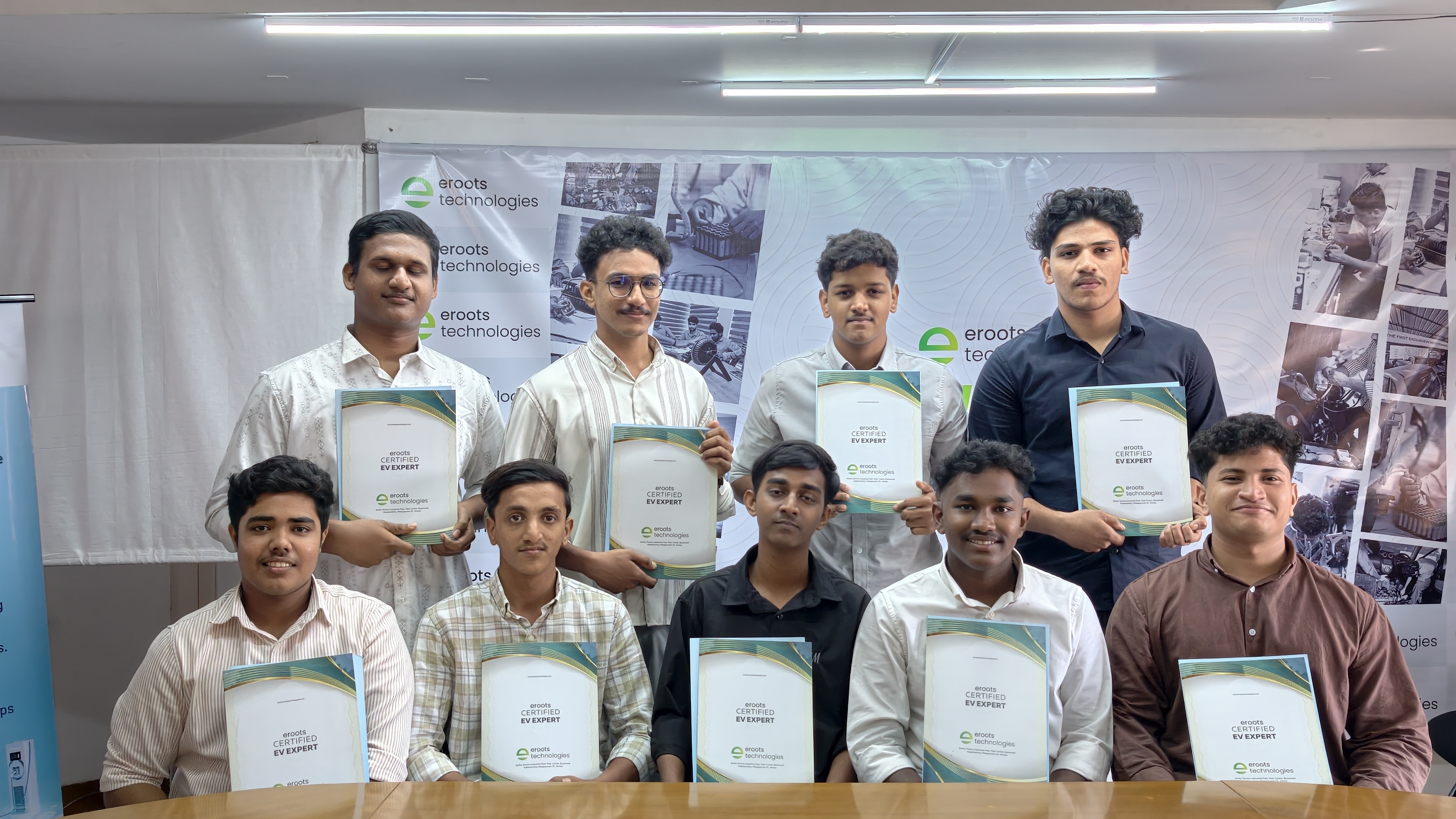 Students posing with certificates after Eroots Technologies program.