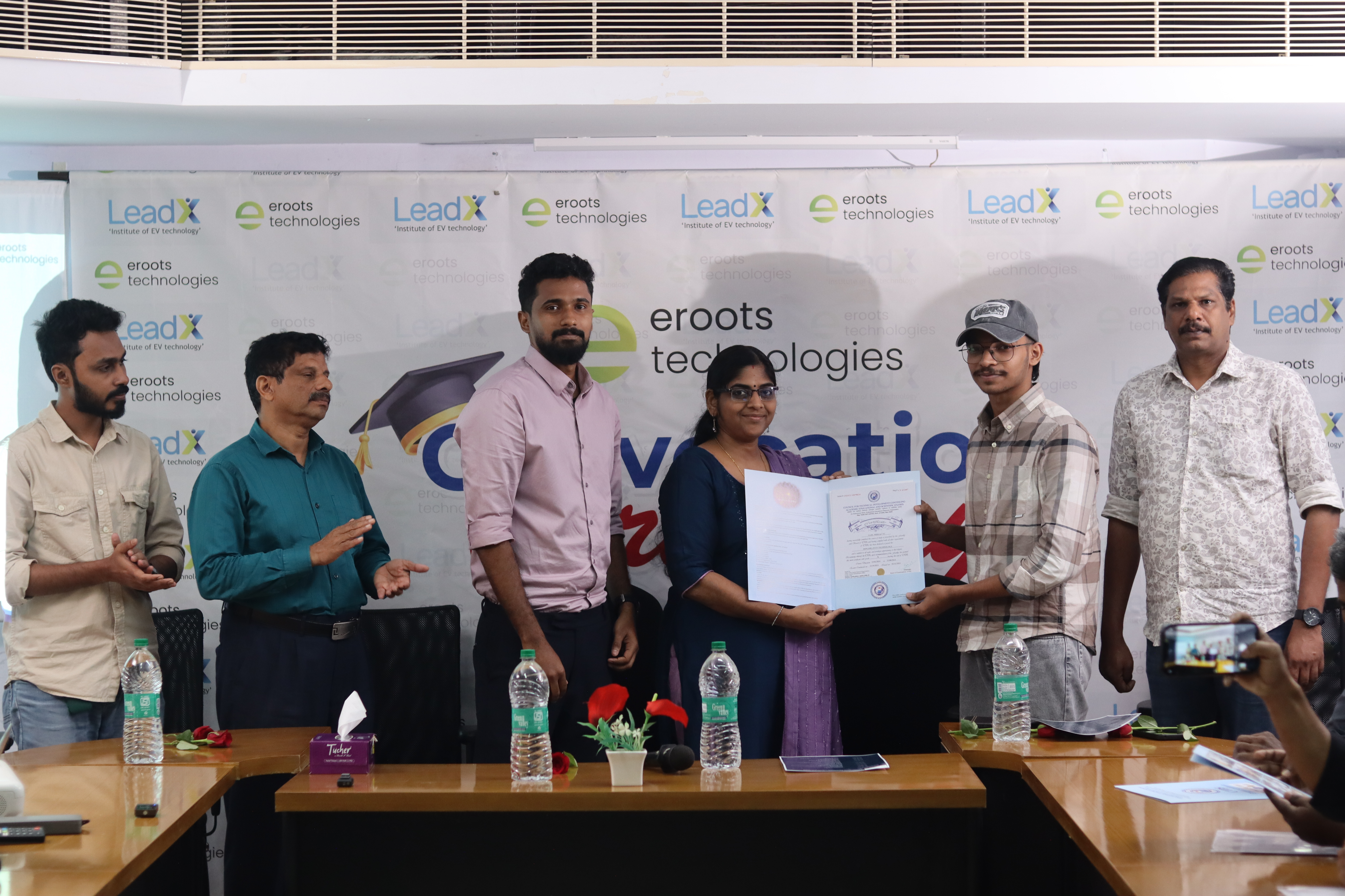 Certificate presentation moment with student and faculty.