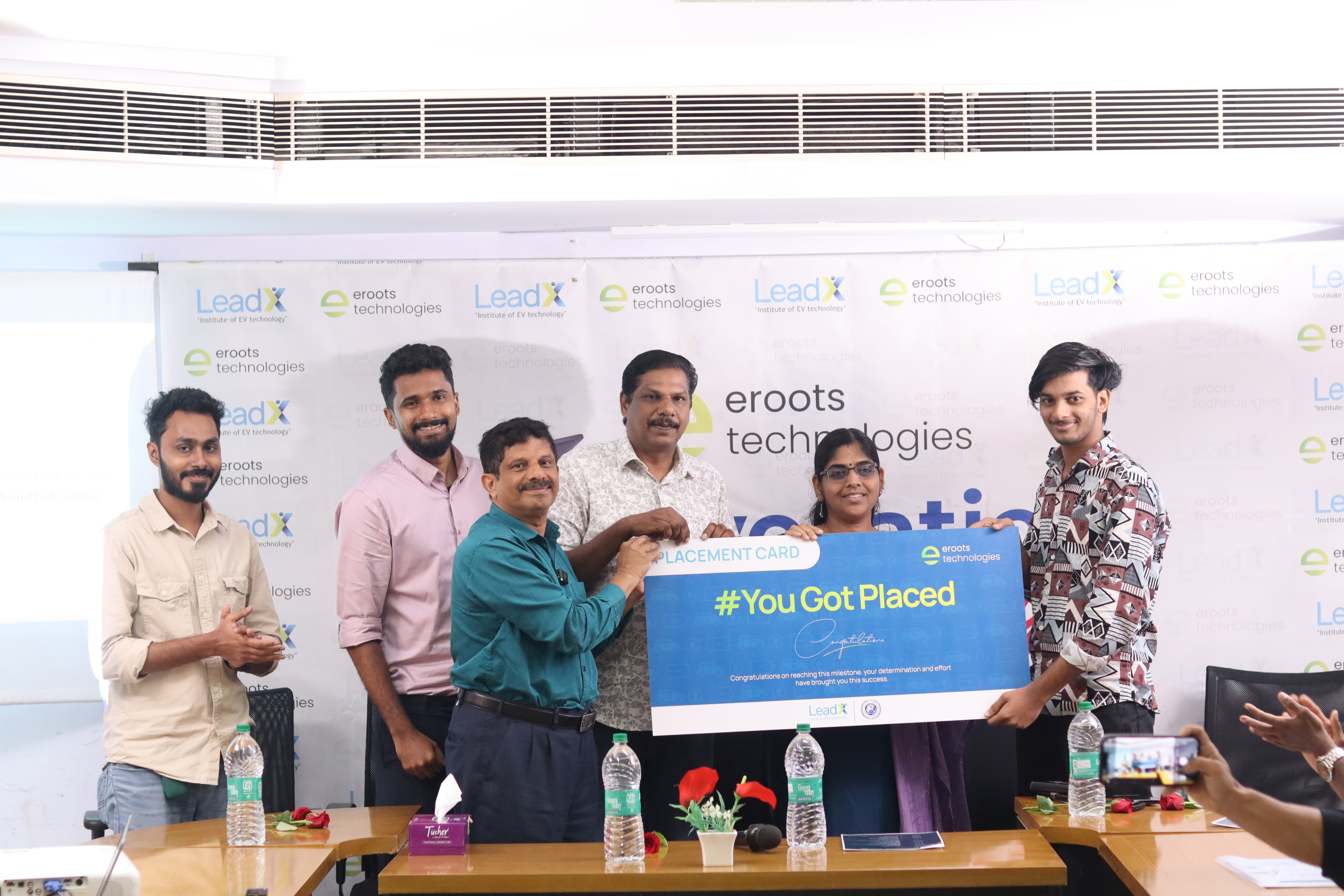 Placement card celebration with Eroots Technologies team.