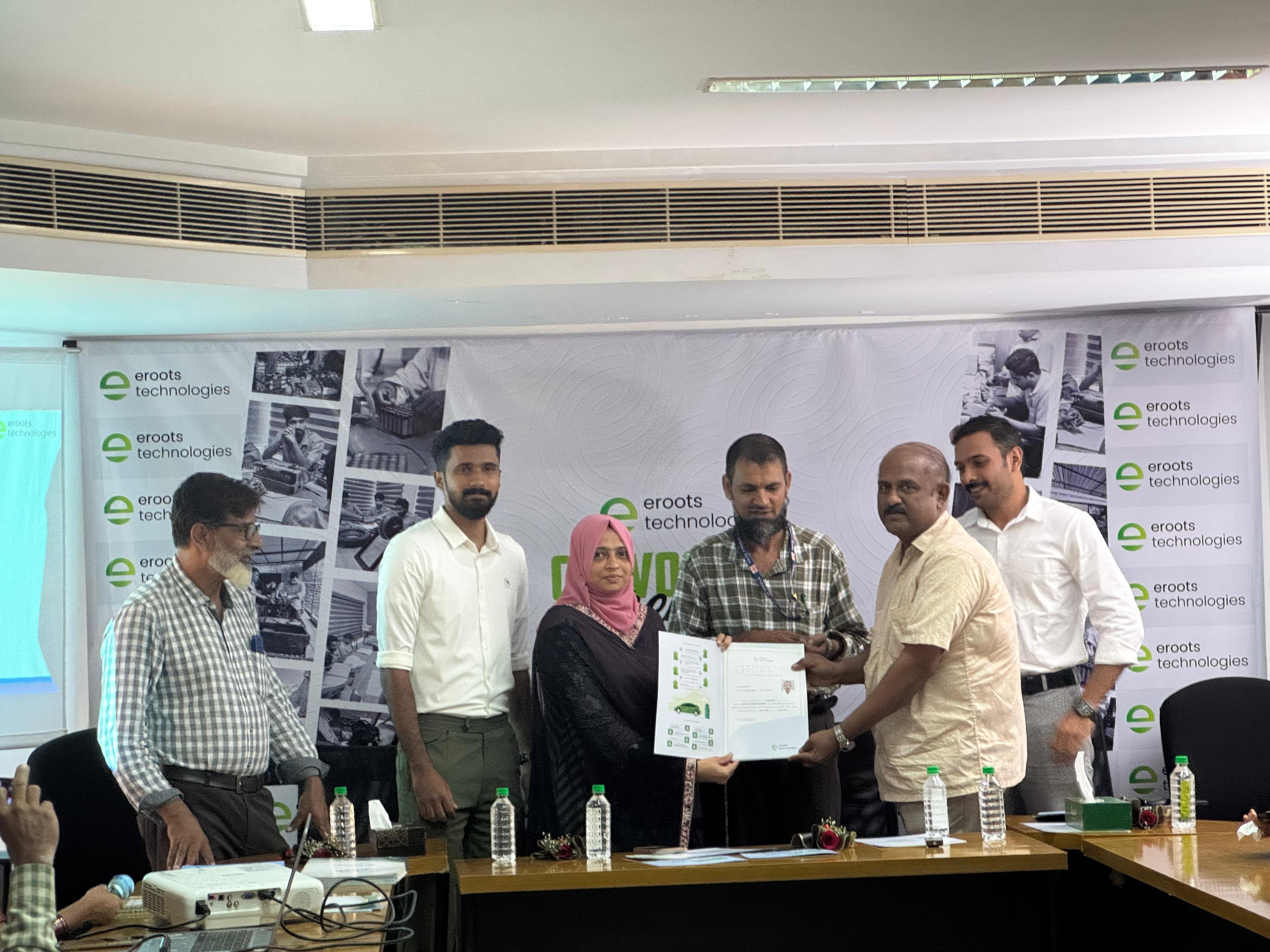 Certificate handover scene during Eroots Technologies function.