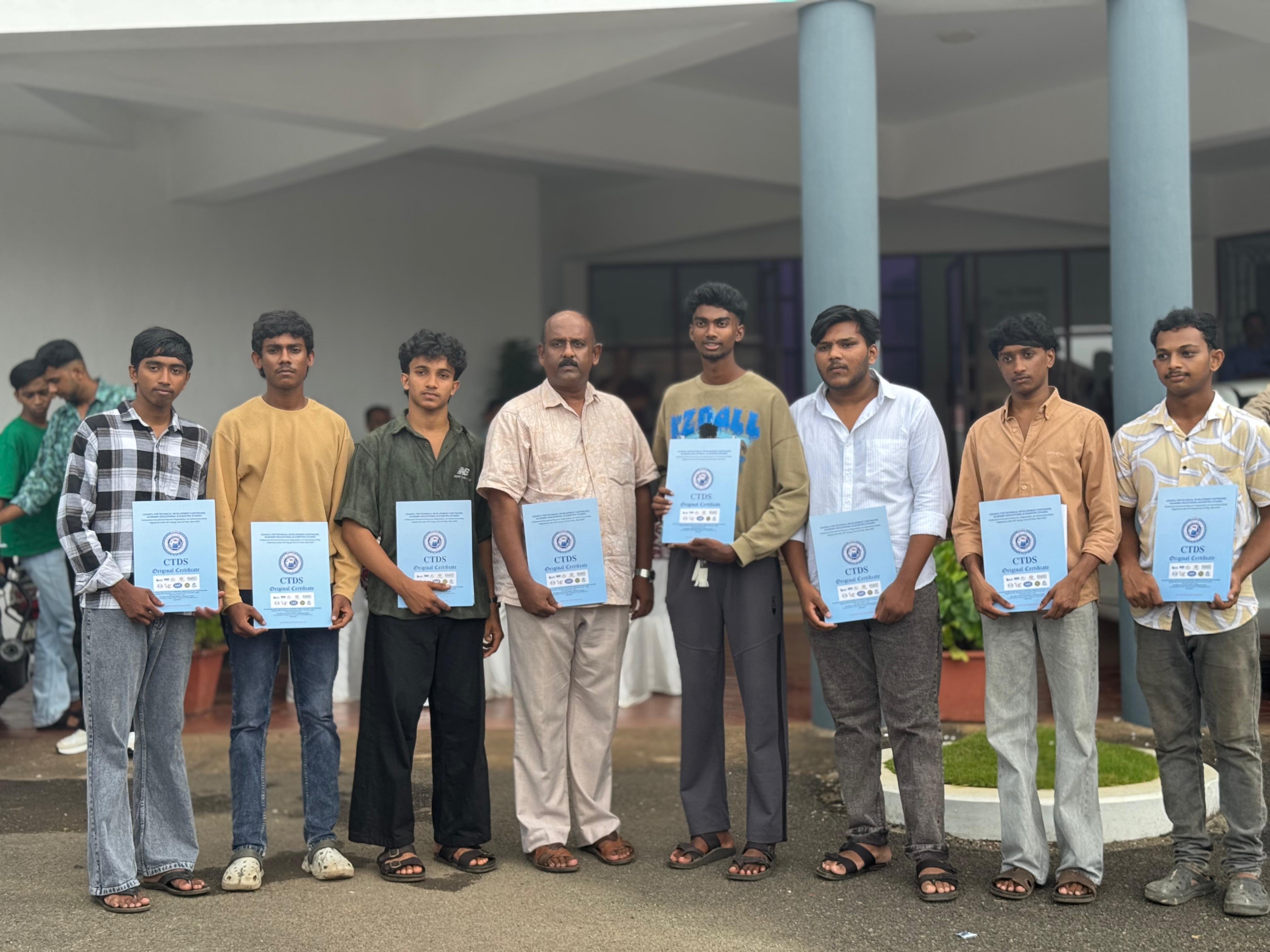 Students standing with certificates outside Park Centre.