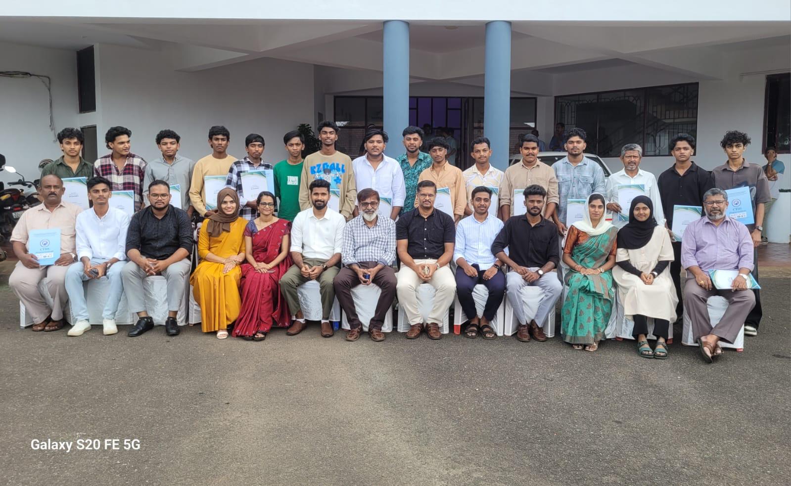 Large group photo of students and staff at Eroots Technologies.
